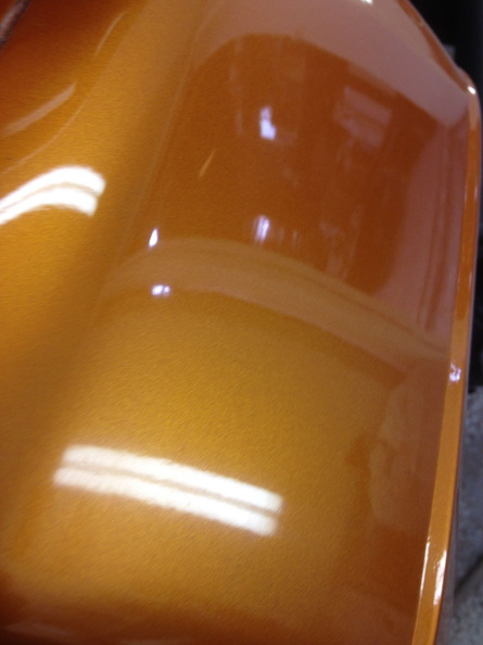 Close-up of candy orange paint with a mirror gloss finish